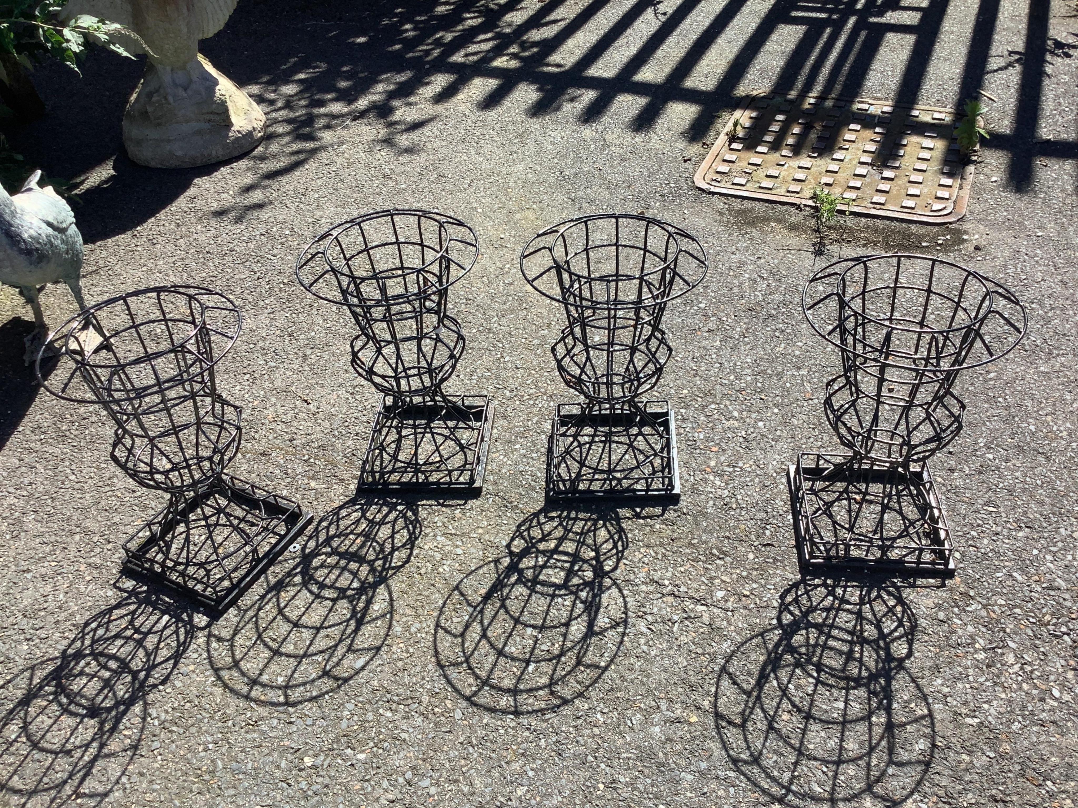 A set of four wirework plant holders, diameter 27cm, height 40cm. Condition - good